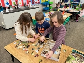 Kids making puzzles. 