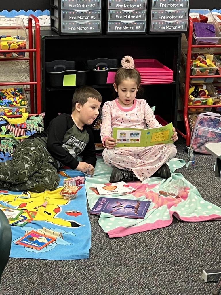Girl reading to a boy. 