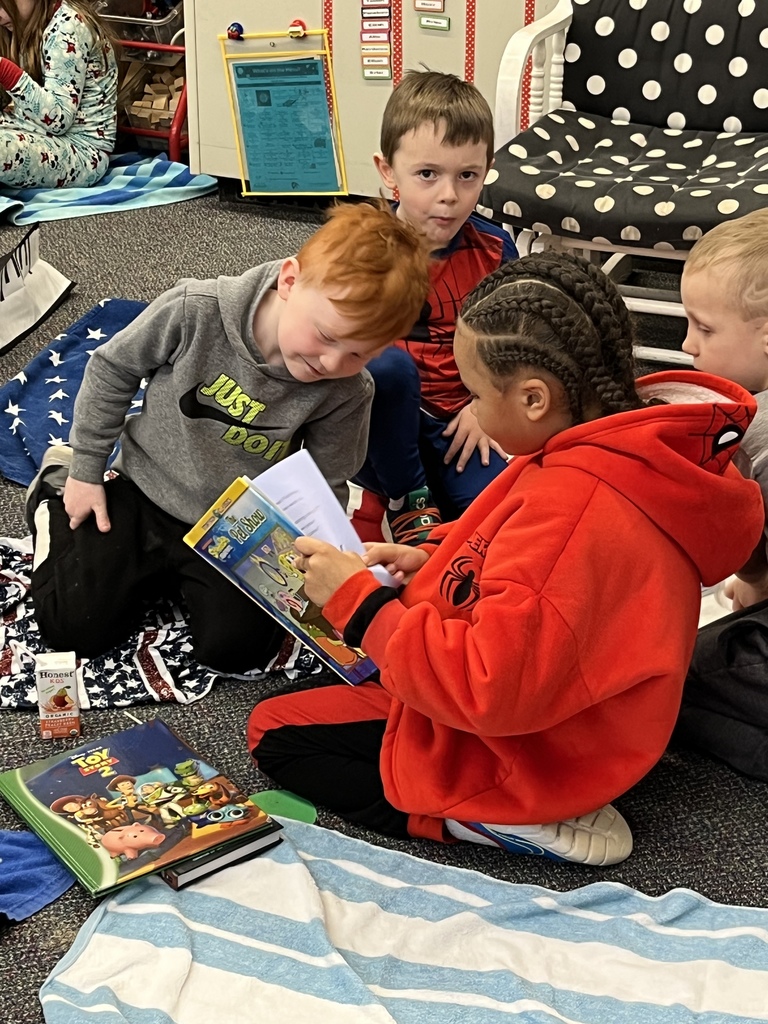 Boys reading a book.