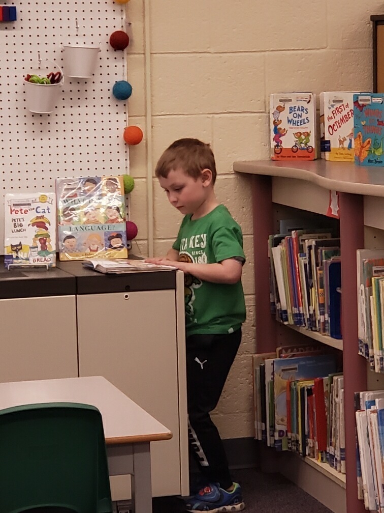 First grade student looking for the perfect book.
